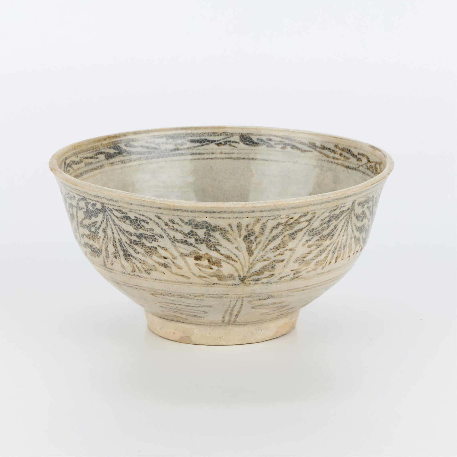 Thai Kalong Chrysanthemum Stoneware Bowl: Thai Kalong stoneware bowl with a chrysanthemum motif, ca. 14th-16th century.Provenance: From the Distinguished Personal Collection of Dr. Robert Jacobsen.Height: 3 1/2 in x diameter: 7 1/2 in.