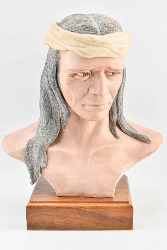 Edward J. Rohn Bust of Native American: Porcelain bust style sculpture by Edward J. Rohn depicting a Native American with long grey hair and wearing a beige headband. Signed on back and numbered 80. 13"H x 10 1/2"W x 6 1/2"D.