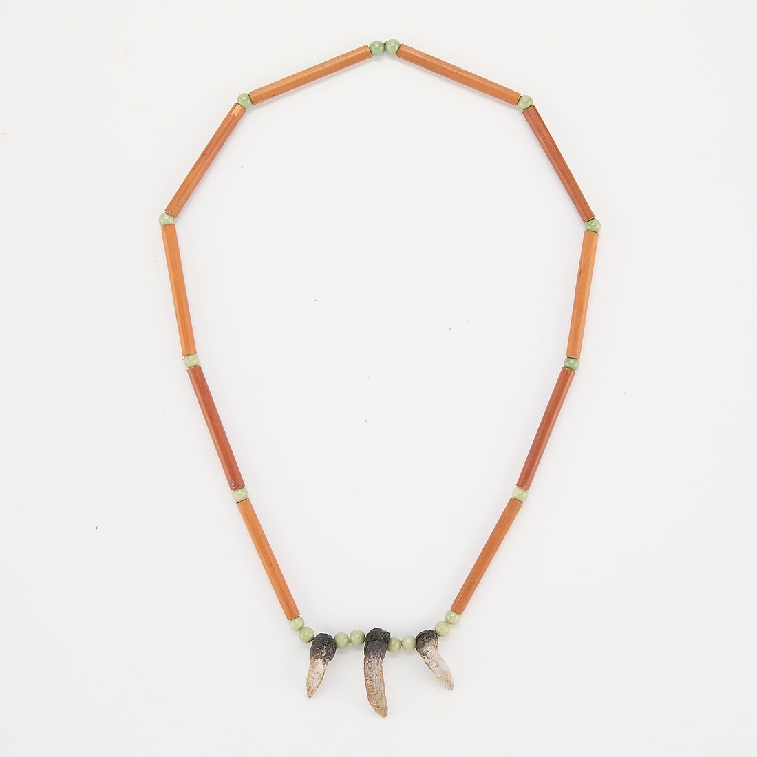 Vintage Southwest Native American Claw Necklace: Vintage Southwestern Native American necklace strung with round pale green and tan tubular beads, culminating in three talon or claw charms.24"L