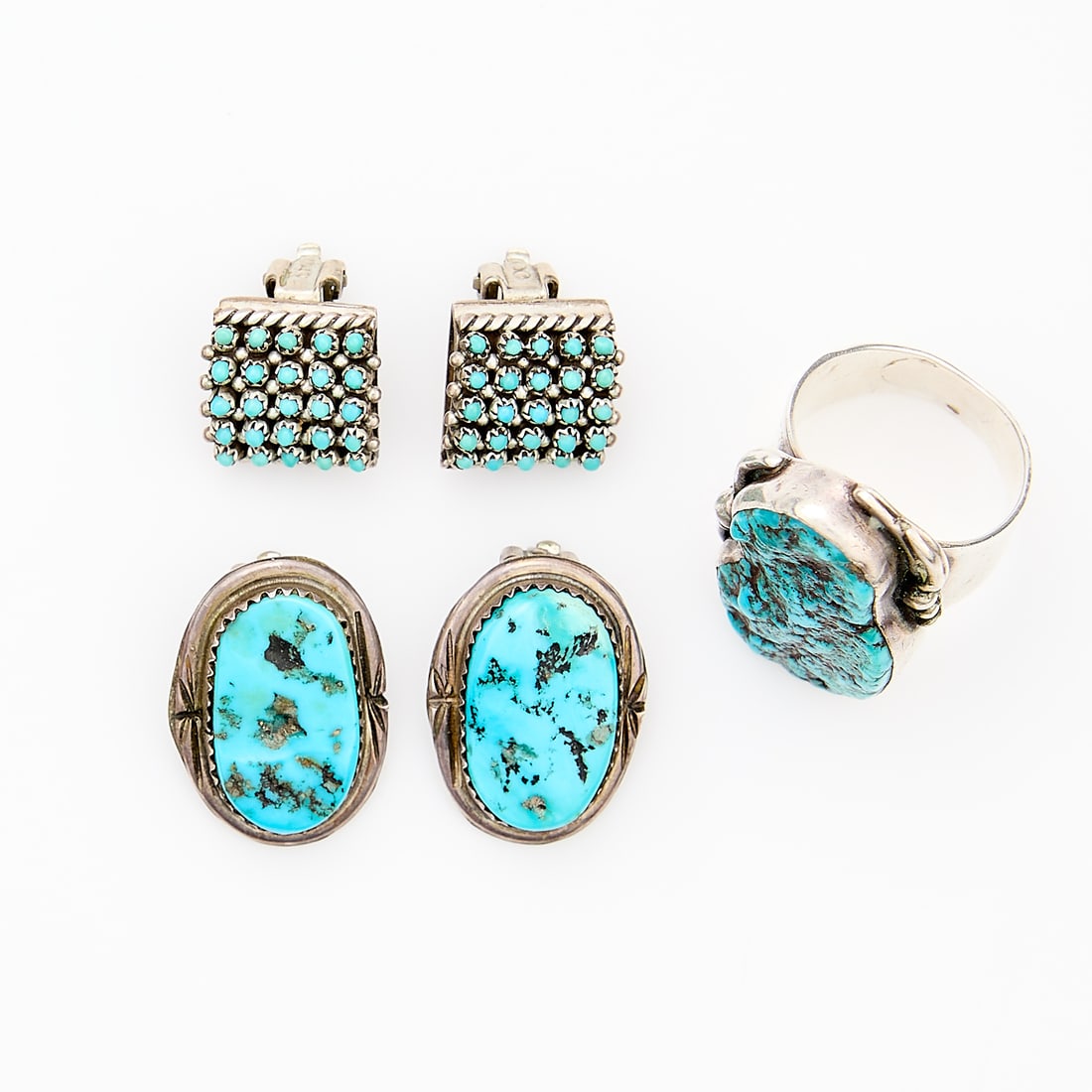 Navajo Turquoise Ring & 2 Pairs Earrings: Group of Najavo silver and turquoise jewelry including: one sterling silver ring set with an amorphous Kingsman mine turquoise signed D. Robert Smith; pair of snake-eye turqouise clip-on earrings, eac