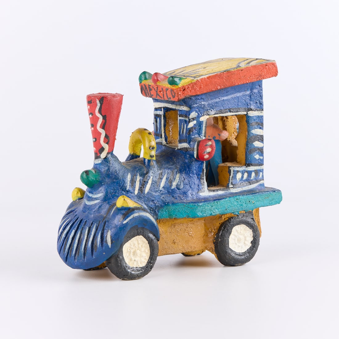 Candelario Medrano Tonala Folk Art Pottery Train: Candelario Medrano (Mexican, 1918-1986). Vintage folk art painted and burnished Tonala "Tlaquepaque" style pottery sculpture in the form of a vibrant train car with a figure in the conductor