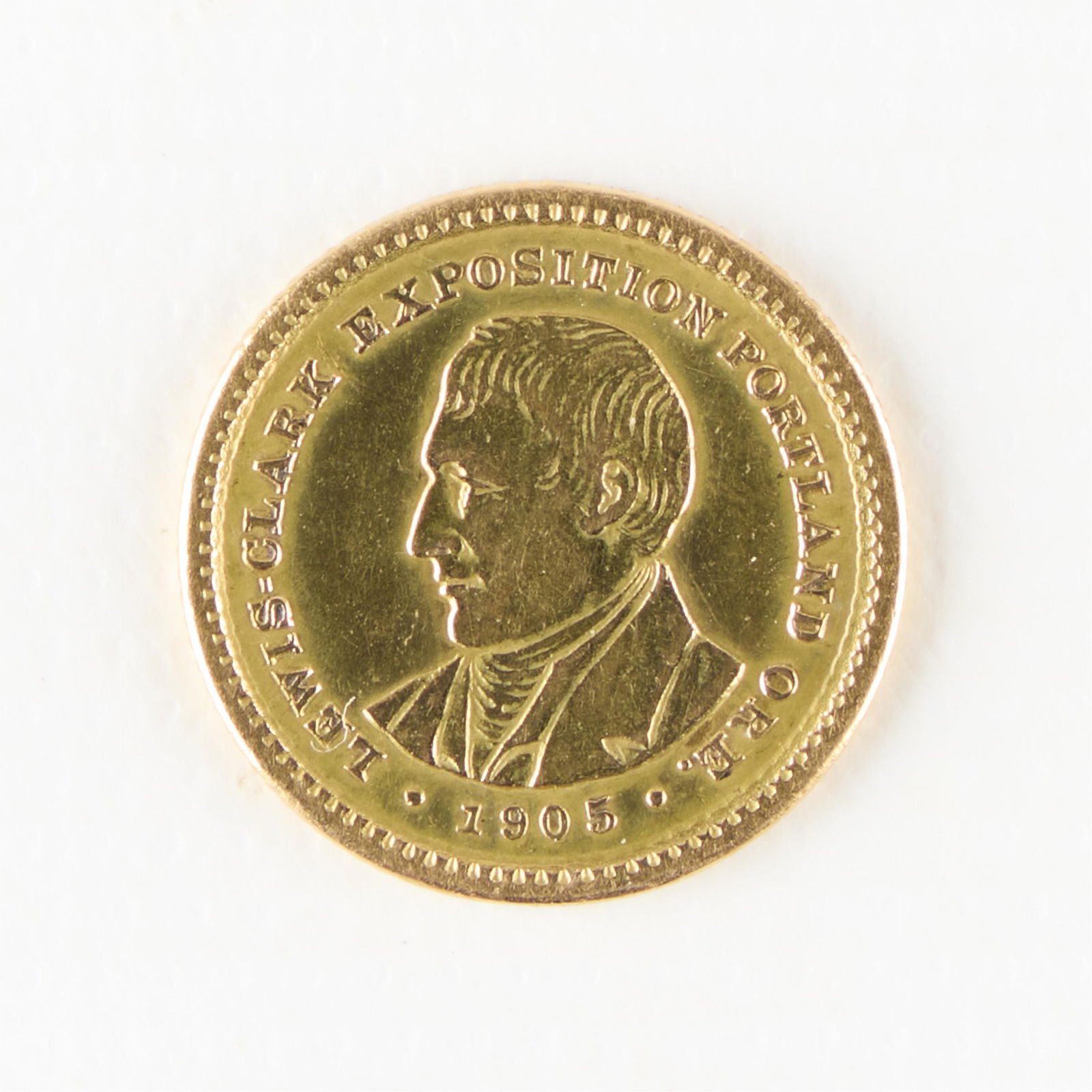 1905 Gold $1 Lewis & Clark Expo Coin: 1905 gold $1 Lewis and Clark Expo commemorative coin. Designed by Charles E. Barber, the coin features bust portraits of explorers Meriwether Lewis and William Clark. Struck as part of the government'