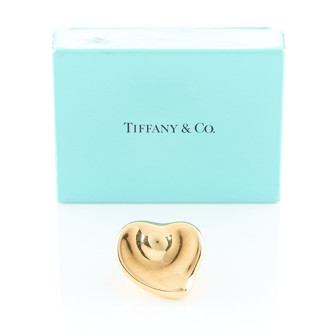 Tiffany & Co. Elsa Peretti 18k Heart Brooch: Elsa Peretti for Tiffany & Co., New York. 18k yellow gold puffy heart brooch. With a locking safety clasp closure. Engraved "Norene/ 20 Years +/ Wm. Bounds Family/ 1997. Marked Tiffany & Co. Elsa