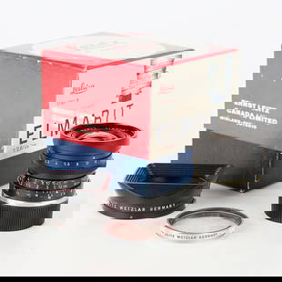 Leica Leitz Elmarit-M 28mm f2.8 Lens: Leitz, Canada. Lens, 28mm f2.8 Elmarit-M, Serial #2524685. Black finish, produced in 1972. With original box. Lens fitted with Leitz SL lens filter and Leitz 12501 lens hood.(Box) height: 4 1/4 in x w