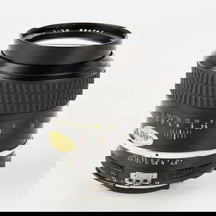 Nikon Nikkor Ai 105mm f2.5 Lens: Nikon, Japan. Lens, 105mm, f2.5 Nikkor Ai, Serial #854741, produced 1977-1981. With a Nikon HS-8 lens hood. With a case.(Case) height: 5 1/2 in x diameter: 3 1/2 in.