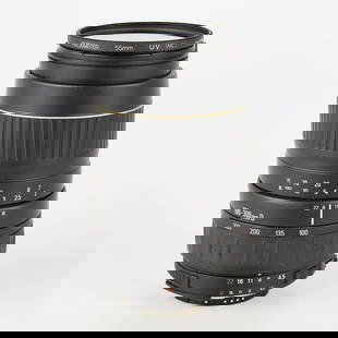 Quantaray for Nikon AF 100-300mm f4.5-6.7 Lens: Quantaray, Japan. Lens, 100-300mm D, f4.5-6.7, Serial #1226960. With a Promaster 55mm UV (MC) lens filter. With a plastic case.(Case) height: 5 1/2 in x diameter: 3 1/2 in.