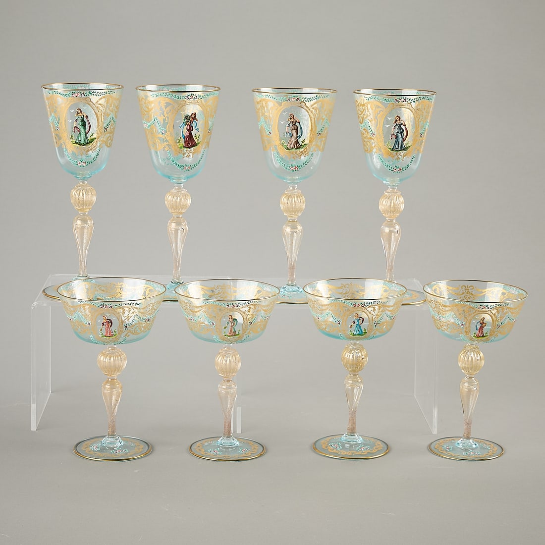 Set 8 Salviati Venetian Glass Stemware: Set of eight Salviati Venetian Italian glass stemware. The set includes four wine glasses and four coupes. Each is hand-painted with gilt rims and decorated with female figures. Gold and light blue ac
