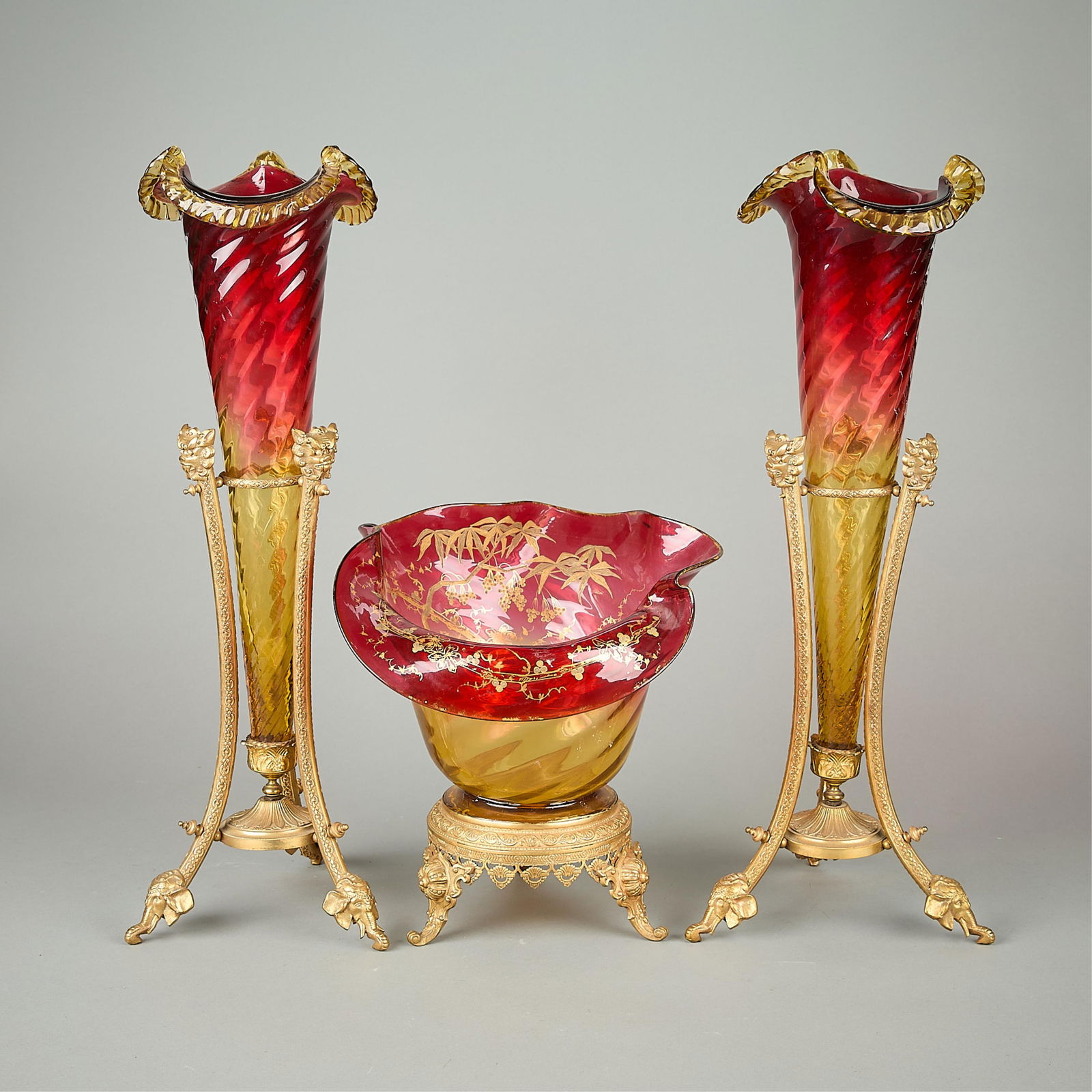 Victorian Ormolu & Amberina Glass Bowl & Epergnes: 19th c. Victorian set of amberina glassware, all with bronze ormolu mounts. Set includes one bowl, featuring gilt rims and hand-painted scenic gilt motifs along the interior, and two trumpet epergnes.