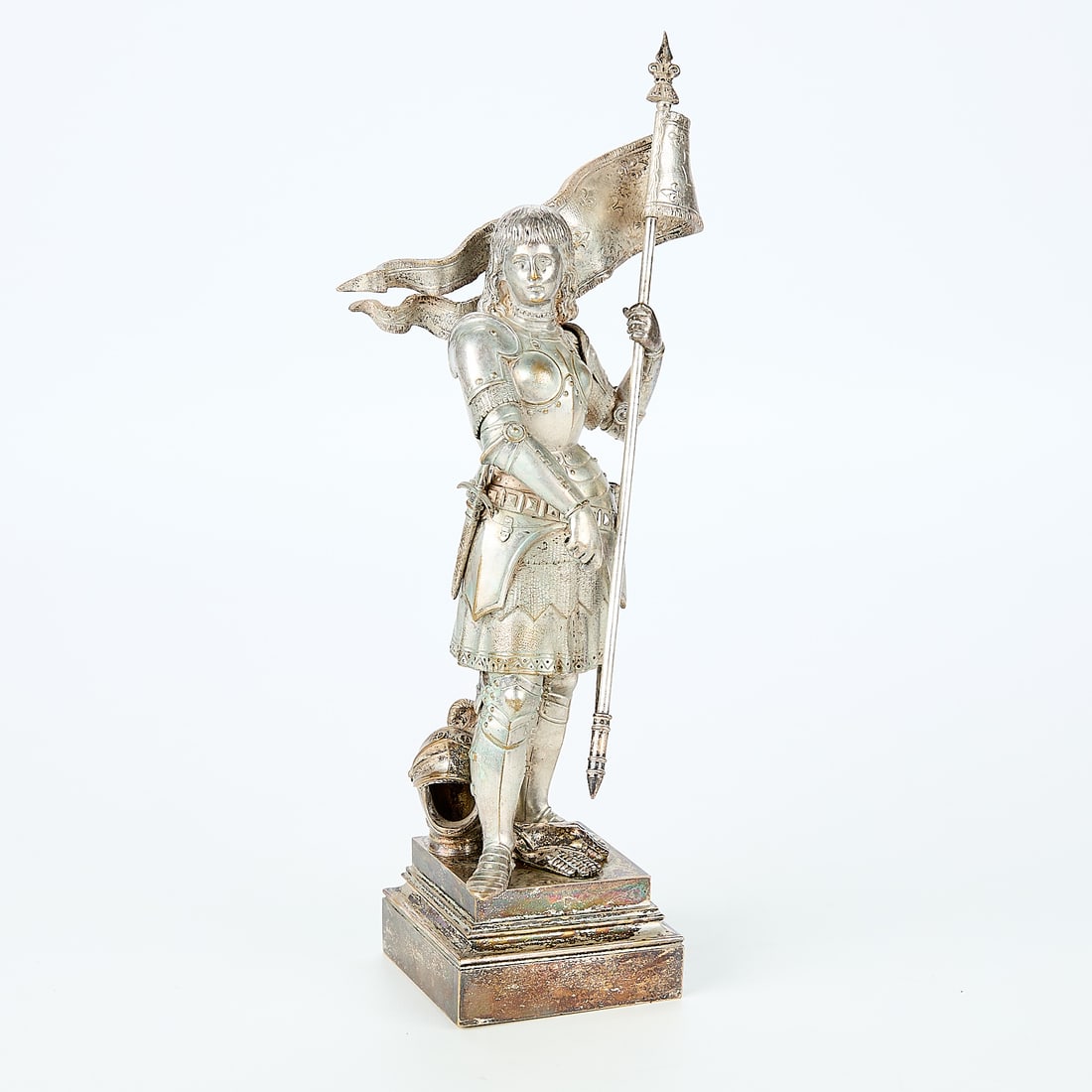 19th c. After Jean-Baptiste Germain "Jeanne d'Arc": 19th century "Jeanne d'Arc" metal sculpture after Jean-Baptiste Germain (French, 1841-1910). Depicting Joan of Arc in her military armor holding a flag featuring fleur-de-lis, the Duke of Or