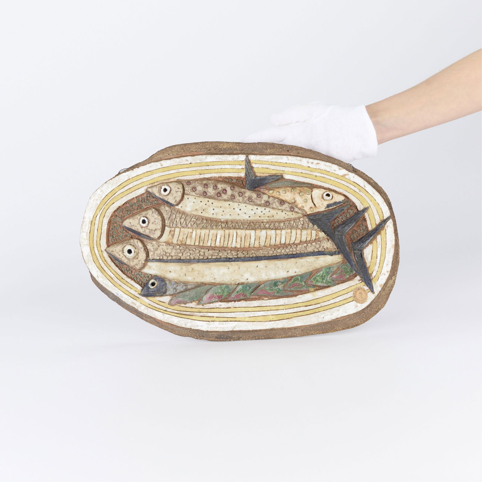 Tyra Lundgren Studio Ceramic Fish Plaque ca. 1970: Tyra Lundgren (Swedish, 1897-1979). Exquisite studio ceramic wall plaque depicting an assemblage of layered fish in relief, possibly mackerel, ca. 1970. Stoneware with several muted and earthy toned g