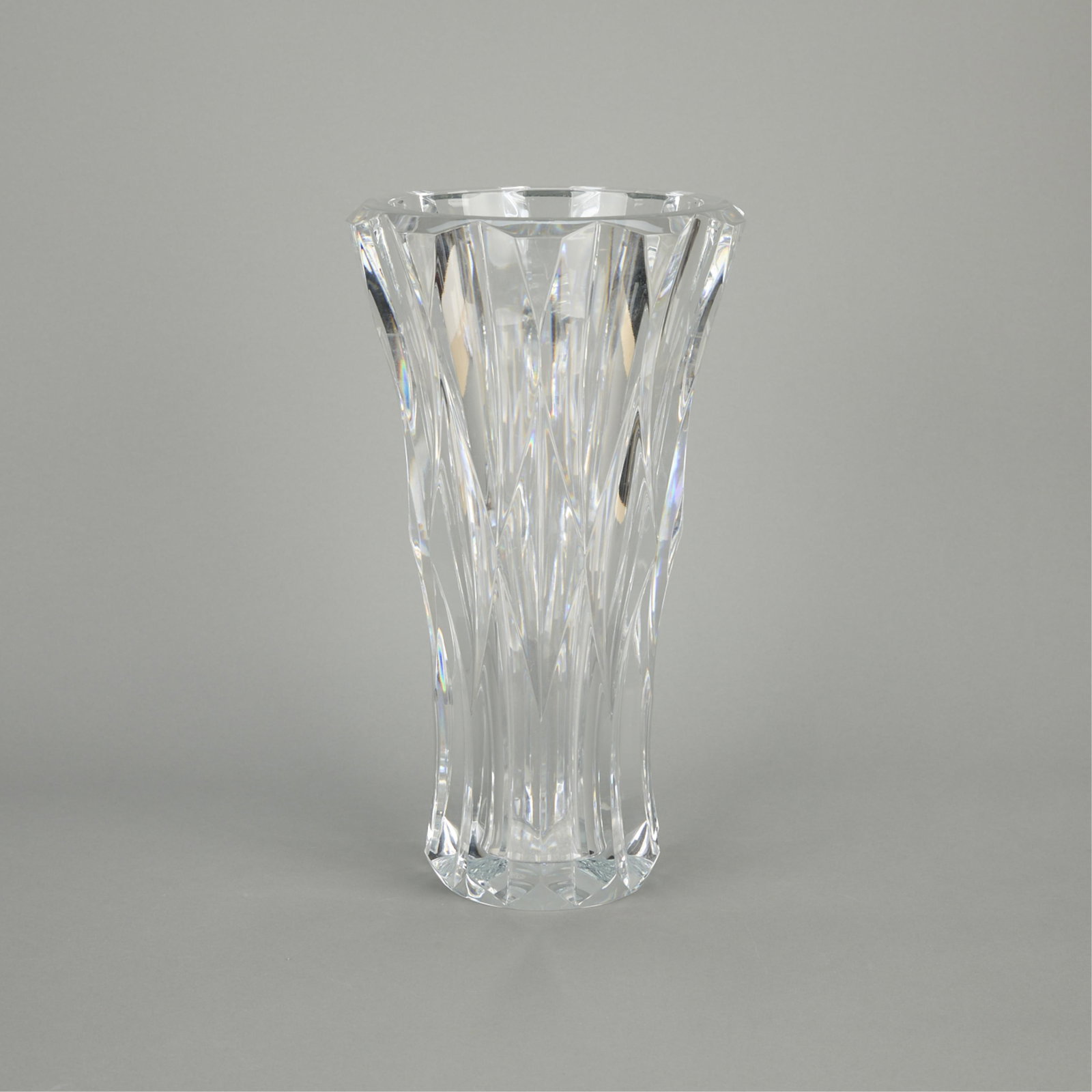 French Baccarat Crystal Glass "Pauline" Vase: Baccarat, France. Cut-glass crystal "Pauline" style vase with flared rim, 20th century. Stamped maker's mark along the underside. Height: 15 in x diameter: 8 1/2 in.