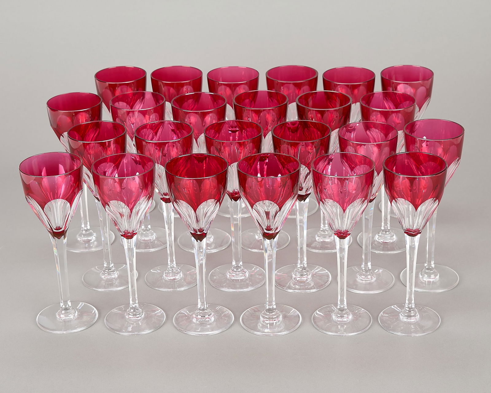 Set 24 St. Louis Bristol Red Hock Cut Stemware: Saint-Louis Crystal, France. Set of 24 crystal wine glasses or goblets in "Bristol Red Hock" pattern. Each decorated with ruby or cranberry cut glass detailing. Marked along the underside.(Each) Heigh
