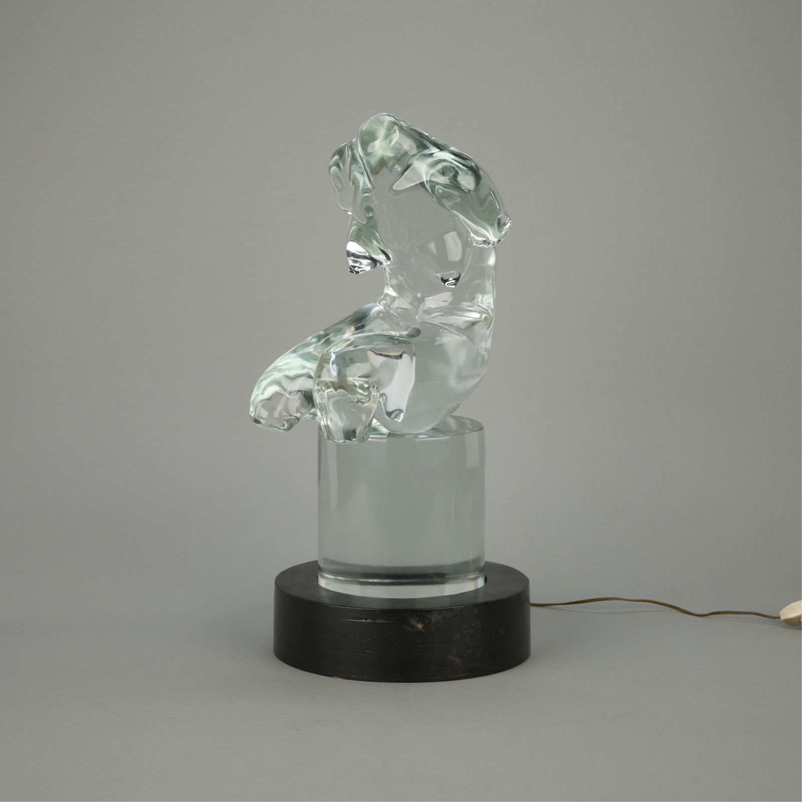 Seguso Murano Glass Figural Sculpture ca. 1980: Livio Seguso (Italian, 1930). Large Murano glass figural sculpture depicting a nude female torso resting atop a cylindrical glass base, ca. 1980. With a wooden lamp platform tha