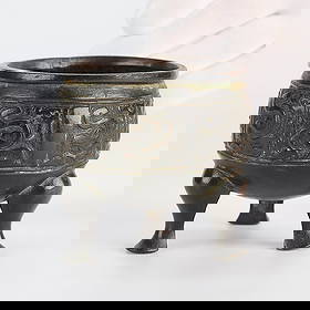 Archaistic Chinese Yuan/Ming Bronze Tripod Vessel: Chinese archaistic bronze tripod censer (ding) or other vessel, Yuan to Ming dynasty. The exterior depicting horned serpents in relief. With ink inscription along the base reading "Ch23" or "ChI," pos