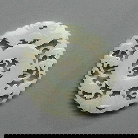 Chinese Qing Carved White Jade Roundel Plaque: Chinese carved and pierced white jade roundel or circular disk plaque, Qing Dynasty, 19th century. Reticulated, depicting a bat, ruyi symbol, and meandering foliage.Diameter: 2 1/4 in. Weight: 26.7 g.