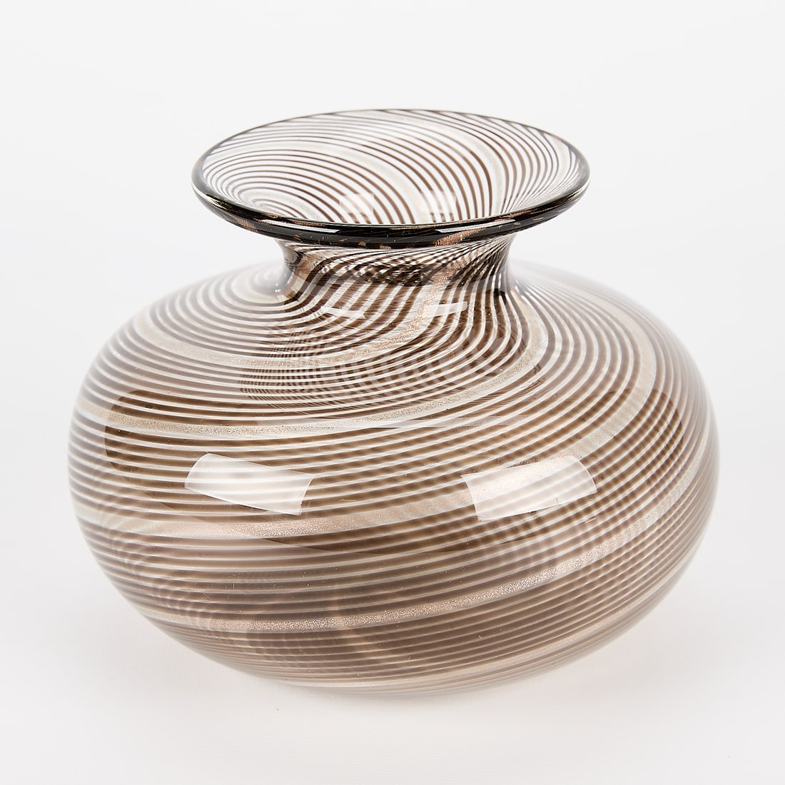 Attrib. Fratelli Toso Murano Glass Vase: Attributed to Fratelli Toso, Italy. Murano art glass vase. Of rounded form with intricate black and gold spiral canework and recessed neck.Height: 4 1/4 in x diameter: 6 in.