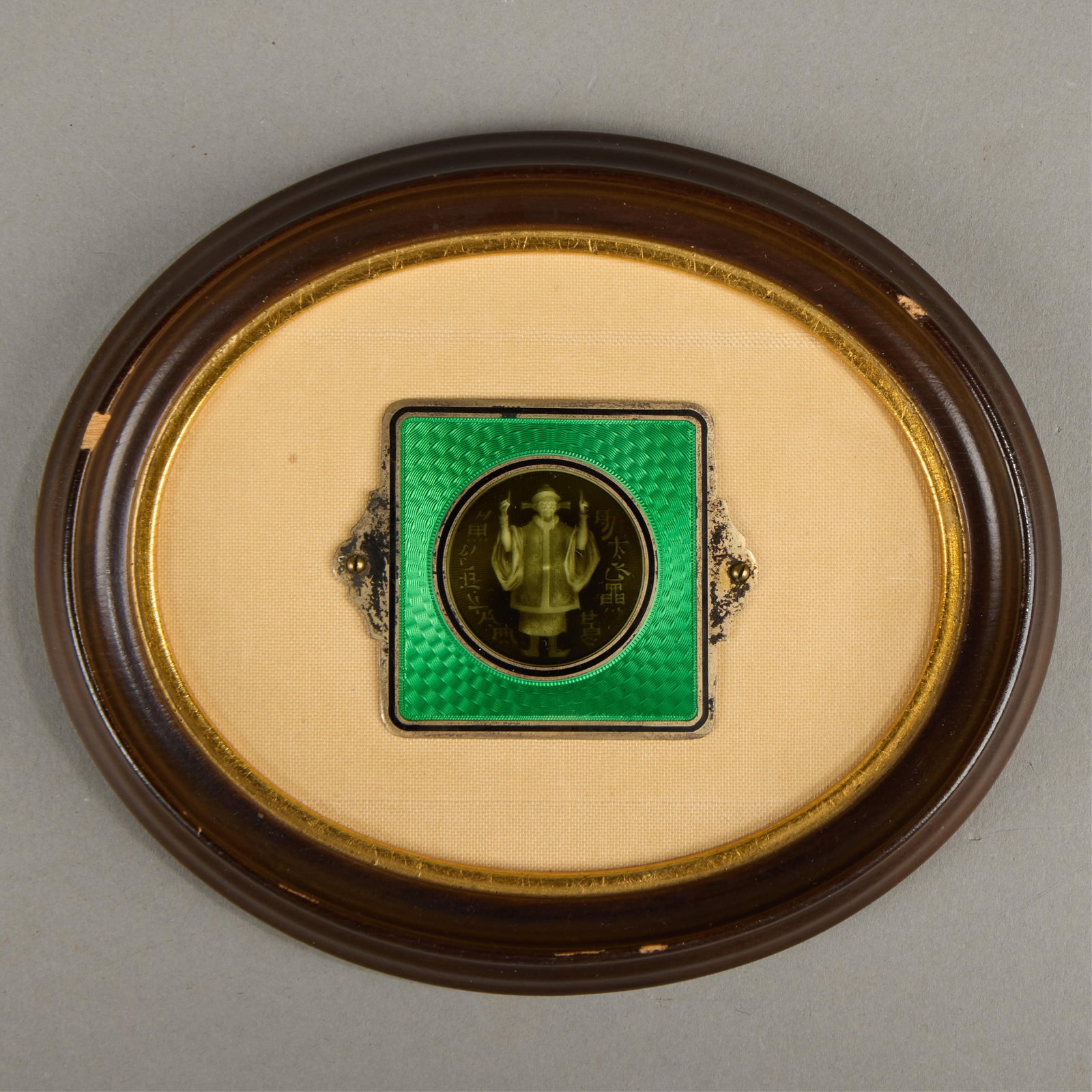 Polak-Aine Parisian Enameled Silver Plaque: Polak Aine (French, 19th-20th century). Art Deco enameled silver plaque depicting a chinoiserie figural medallion surrounded by auspicious characters, ca. 1920s. Mounted atop a fabric backing.Height: