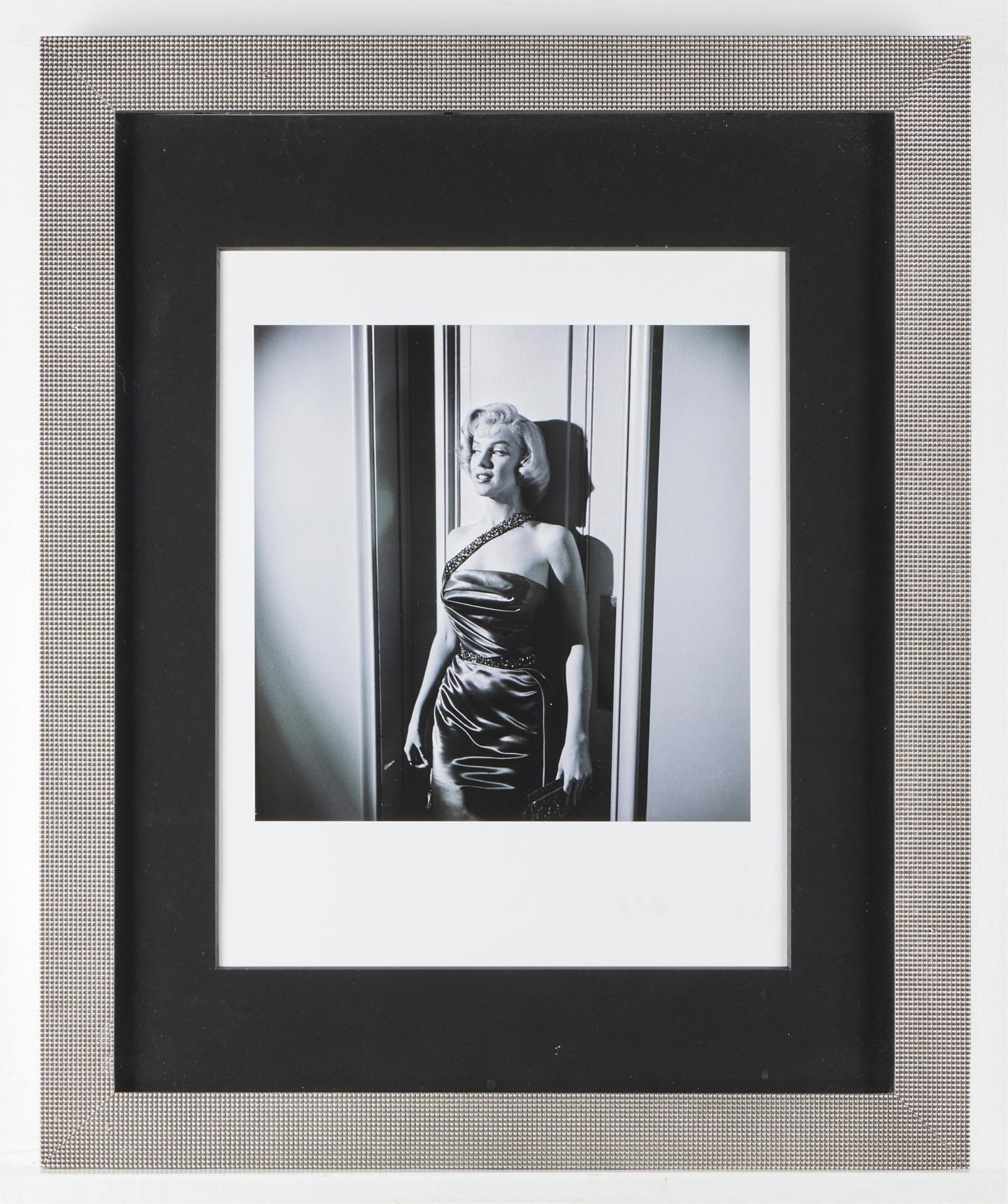 Marilyn Monroe "Marry a Millionaire" Lithograph: Lithograph depicting actress Marilyn Monroe against a wall, from the set of "How to Marry a Millionaire," original photograph taken ca. 1953, printed later. Blindstamped "Frank Worth Estate" along