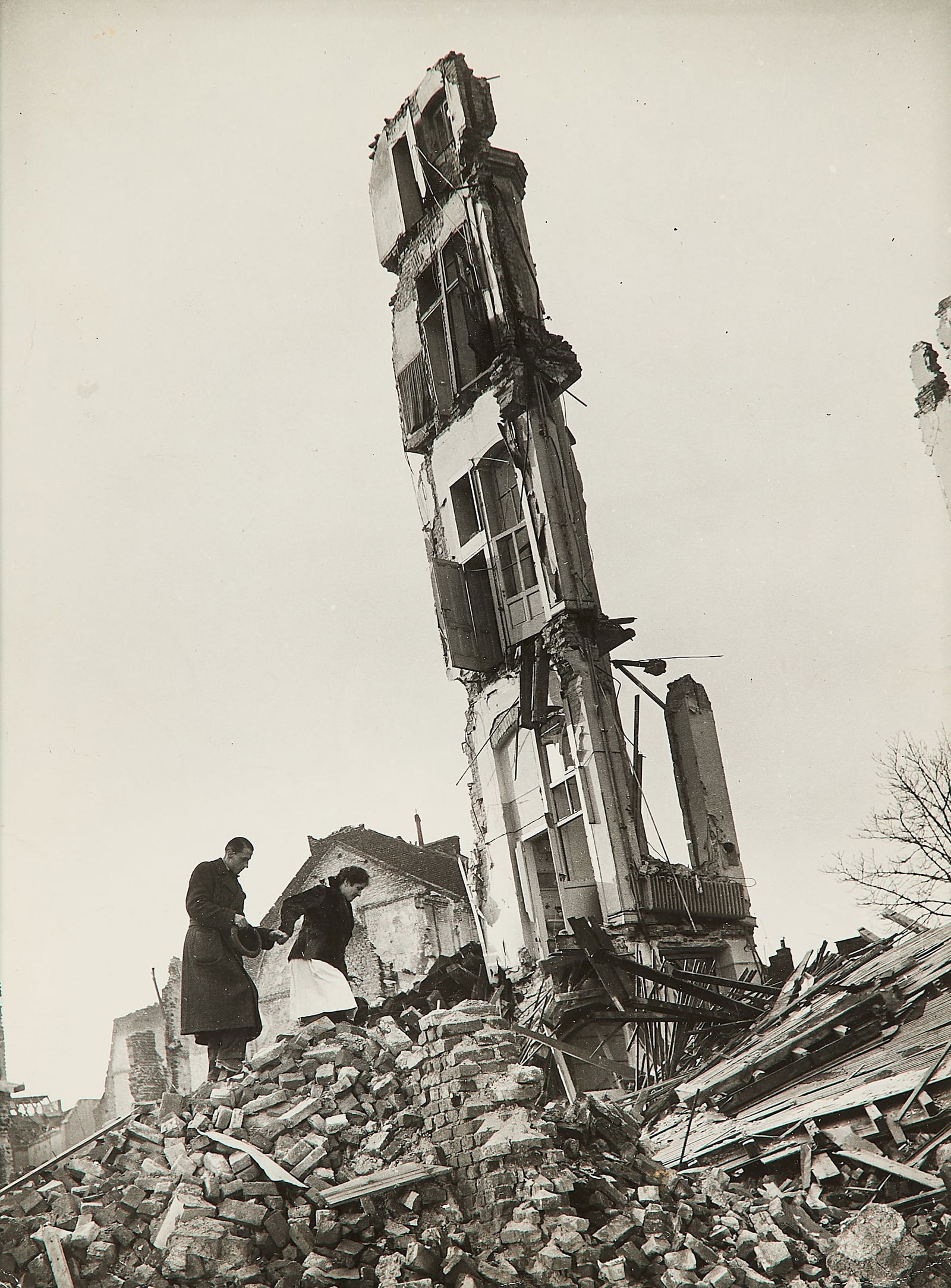 Margaret Bourke-White "Cologne, Germany" Photo: Margaret Bourke-White (American, 1904-1971). Gelatin silver print photograph titled "Cologne, Germany," 1945. Depicting the destruction of World War II with a pair of figures walking among the rubble