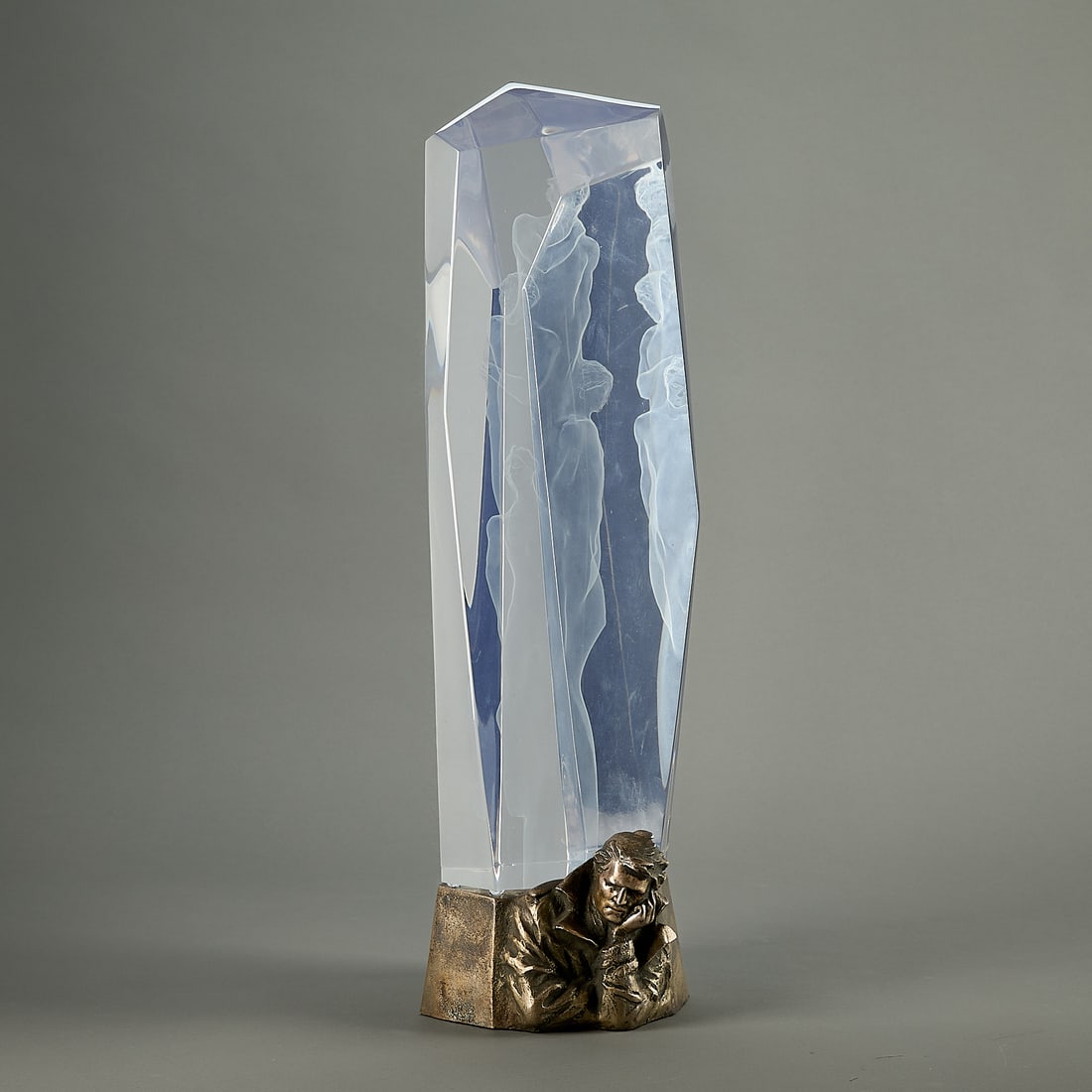 Frederick Hart "Elegy" Acrylic Resin Sculpture: Frederick Hart (American, 1943-1999). Prismatic acrylic resin sculpture titled "Elegy," depicting ethereal figures, etched along the interior, 1990. With weighted metal base featuring a pondering male