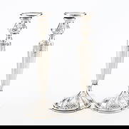 Pr American Weighted Sterling Candlesticks 1965.1g: Redlich & Co., New York. Pair of American weighted sterling silver candlesticks with floral motifs along the base and throughout the body, 1924. Engraved "MWM" along each base; marked "Sterling," "wei