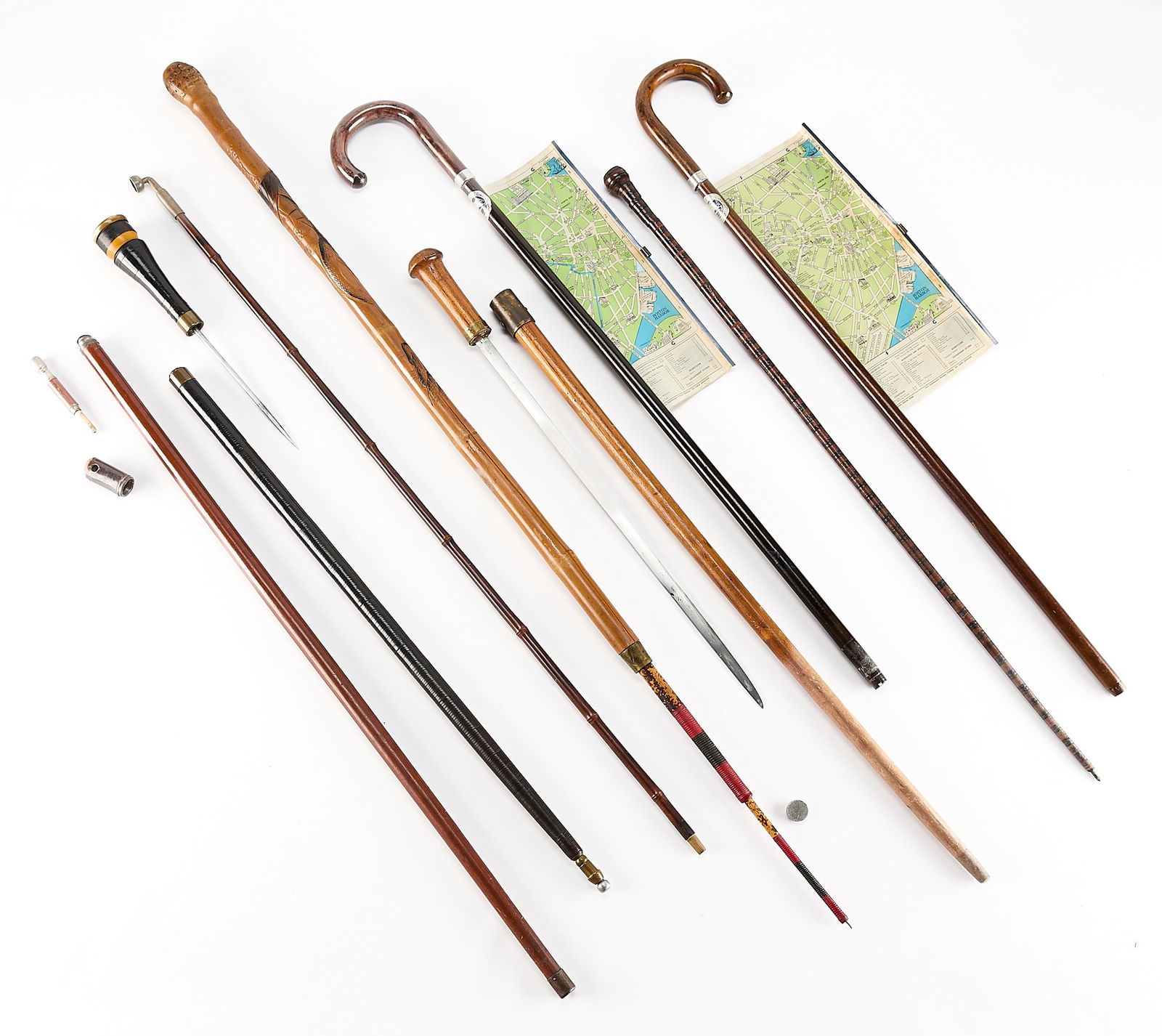 8 Walking, Gadget, Pipe & Sword Canes: Group of eight assorted canes. Including two swordsticks or cane swords, two 1940 American Legion Convention gadget canes with pull-out maps of Boston, Massachusetts, one wooden cane with intricate
