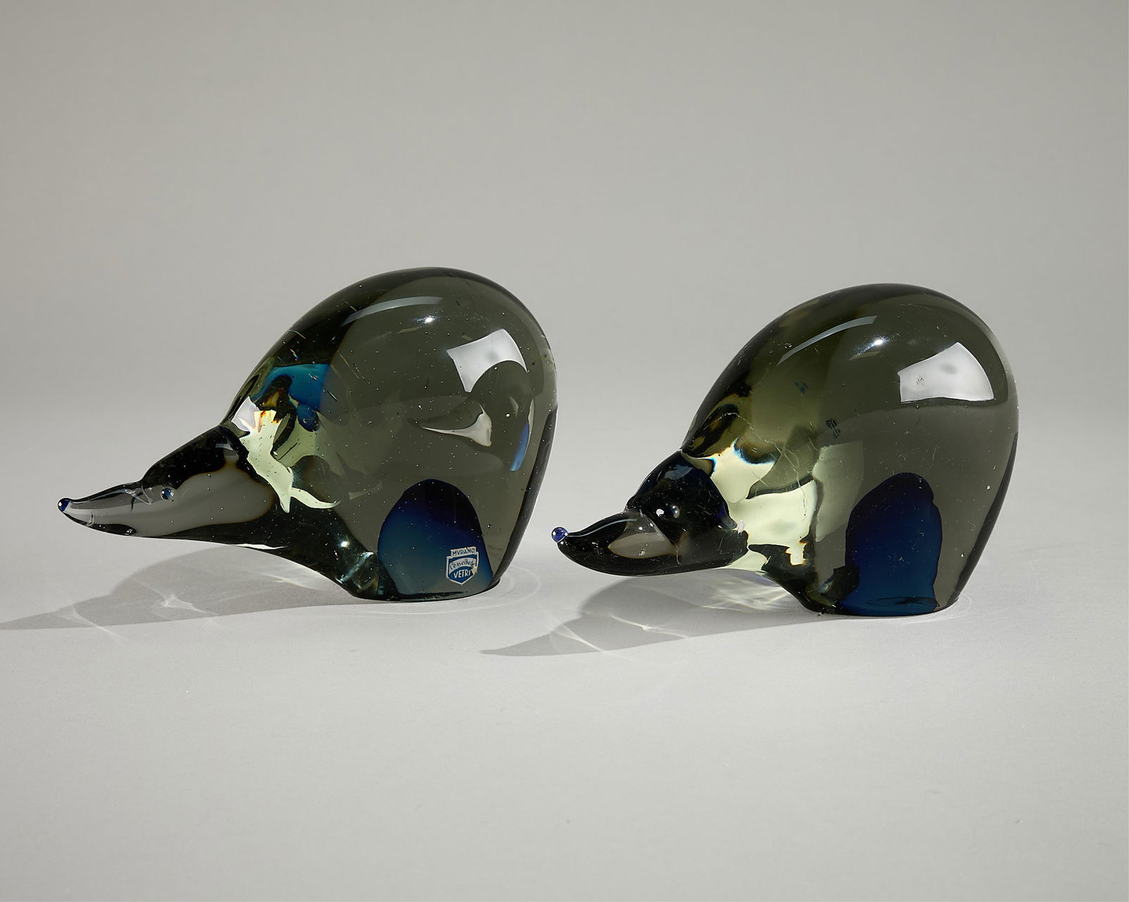 2 Cenedese Murano Glass Sommerso Polar Bears: Cenedese Murano, Italy. Two mid-century modern Murano sommerso glass figurines, paperweights, or bookends in the form of crouching polar bears with elongated snouts. One marked with a sticker. (Each)
