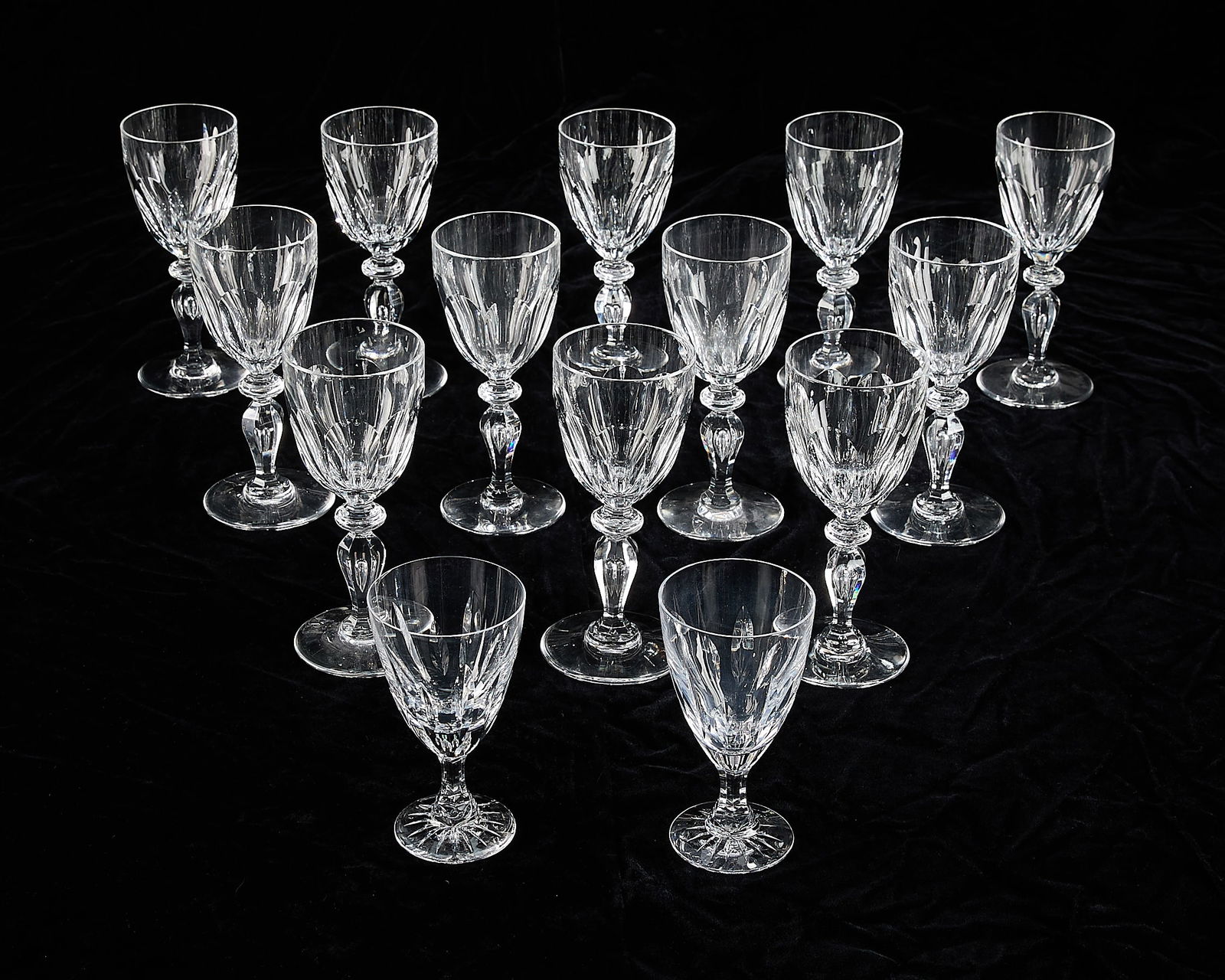 12 St. Louis Crystal & 2 Kosta Boda Wine Glasses: Saint-Louis Crystal, France, and Kosta Boda, Sweden. Group of 12 St. Louis "Alexandre" model cut glass wine goblets, and two Kosta Boda "Martine" model water or wine glasses. Each marked along the