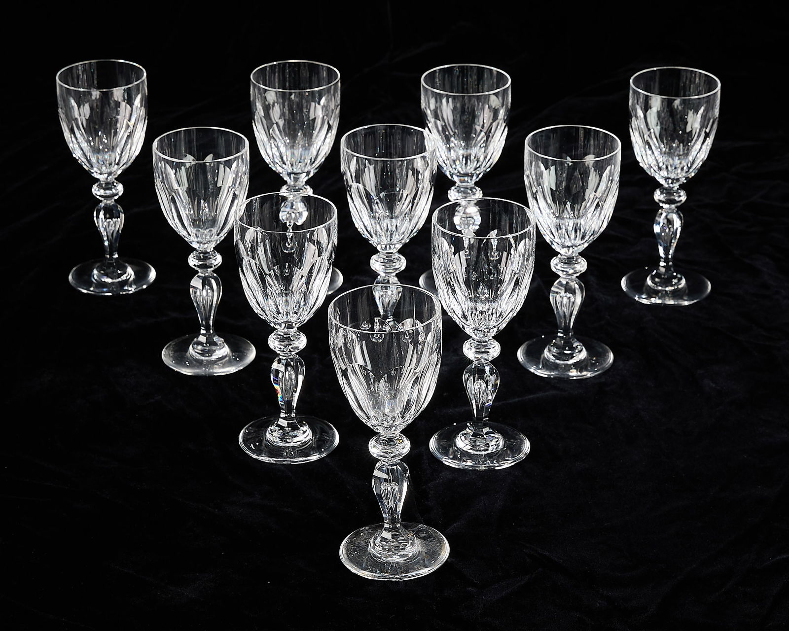 10 St. Louis Crystal "Alexandre" Cut Wine Glasses: Saint-Louis Crystal, France. Set of ten wine glasses in "Alexandre" pattern, 20th century. With geometric cut glass detailing and bulbous stems. Each marked along the underside. (Each) Height: 6 3/4