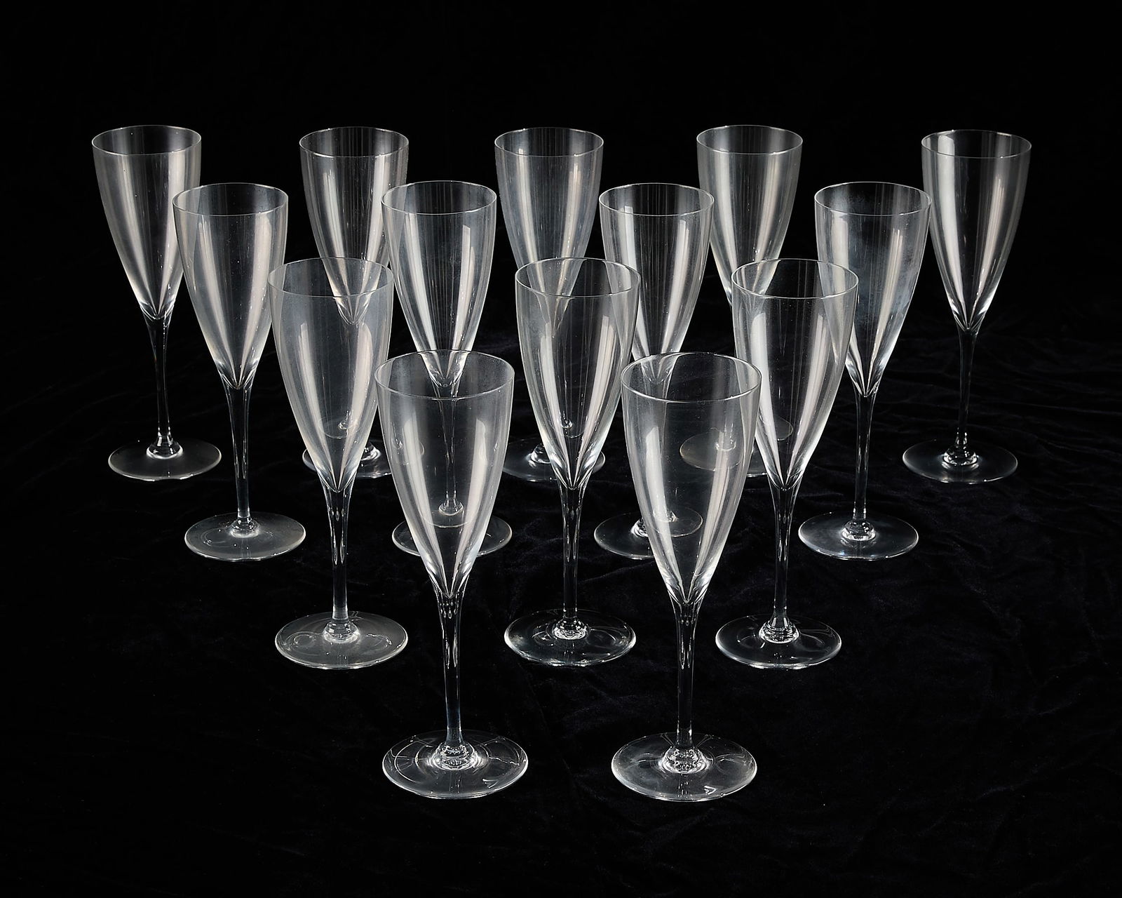 14 Baccarat Crystal "Dom Perignon" Wine Glasses: Baccarat, France. Set of 14 "Dom Perignon" model crystal wine goblets, water glasses, or toasting flutes. Each marked along the underside. (Each) height: 9 in x diameter: 2 3/4 in.