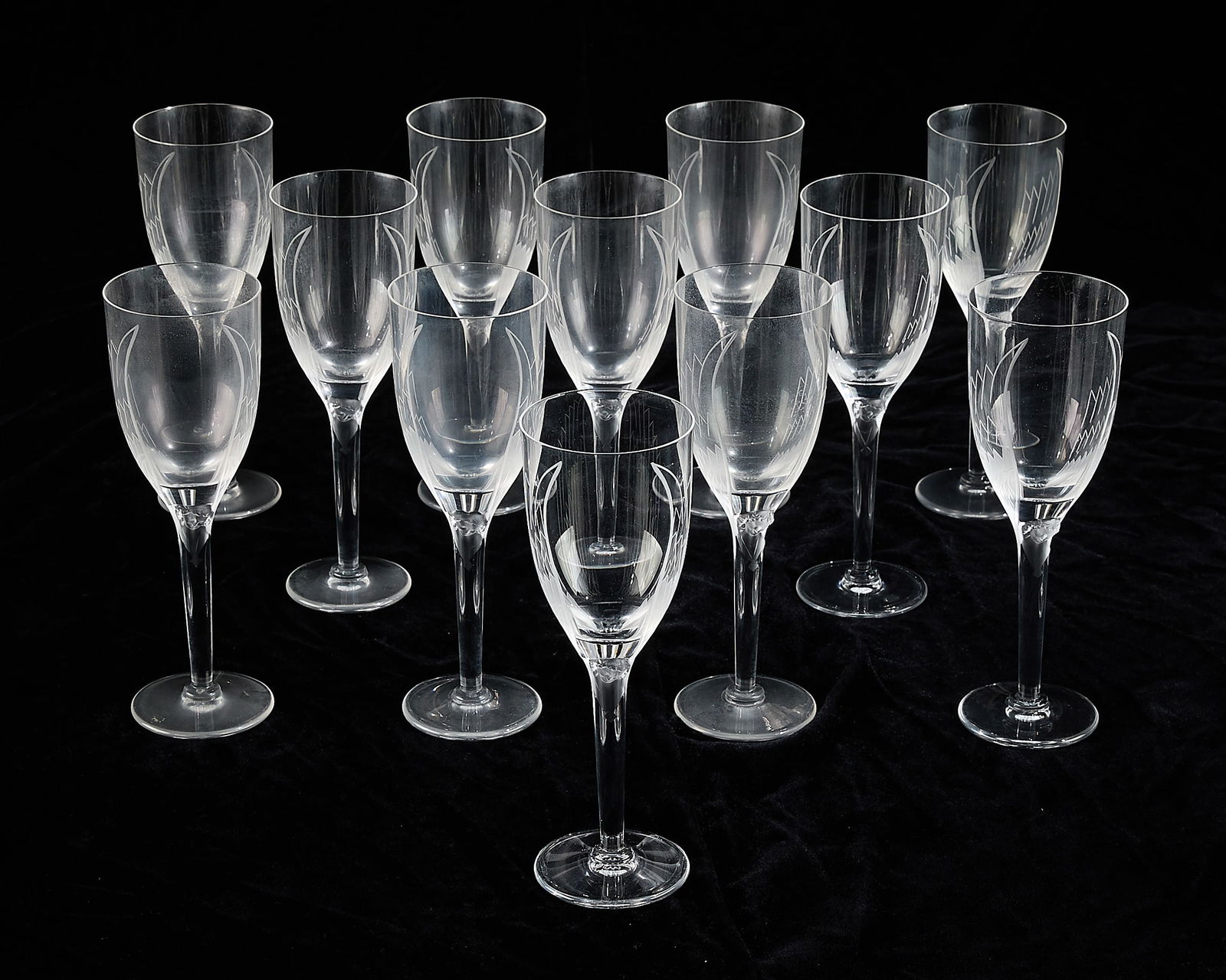 Set 12 Lalique Glass "Ange" Champagne Flutes: Lalique, France. Set of 12 crystal glass champagne flutes or wine glasses in pattern "Ange," 20th century. Depicting molded angels with etched wings in contrasting clear and frosted glass. Each