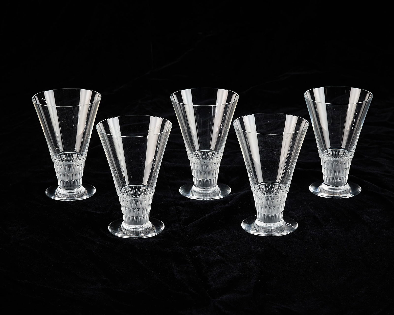 Set 5 Lalique Glass "Bourgueil" Wine Goblets: Lalique, France. Set of five crystal glass water or wine goblets in pattern "Bourgueil," 20th century. Marked along the underside. (Each) Height: 5 in x diameter: 3 1/2 in.