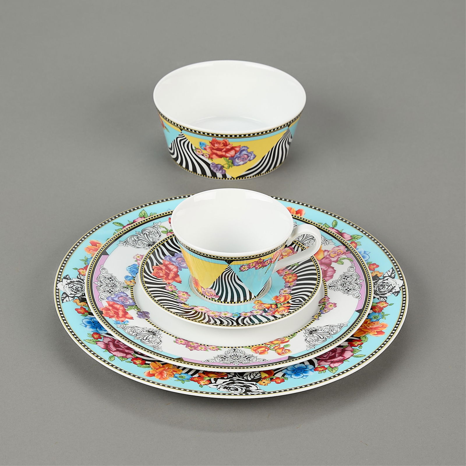 Set 5 Versace for Rosenthal "Hot Flowers" Dishes: Versace for Rosenthal, Germany. Set of five porcelain "Hot Flowers" pattern dishes depicting an eclectic array of floral sprays and zebra motifs against a powder blue ground. Includes one dinner plate
