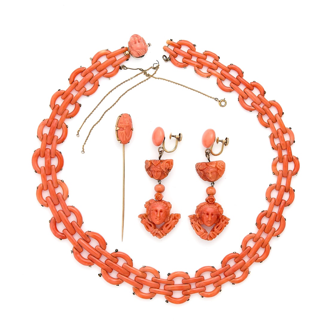 Italian 14k Gold Carved Coral Jwly: Three pieces of Italian 14k yellow gold and carved coral jewelry, including: One carved coral necklace of modified gate links with a carved coral clasp of a cherub. Unmarked, clasp mounting tested as 