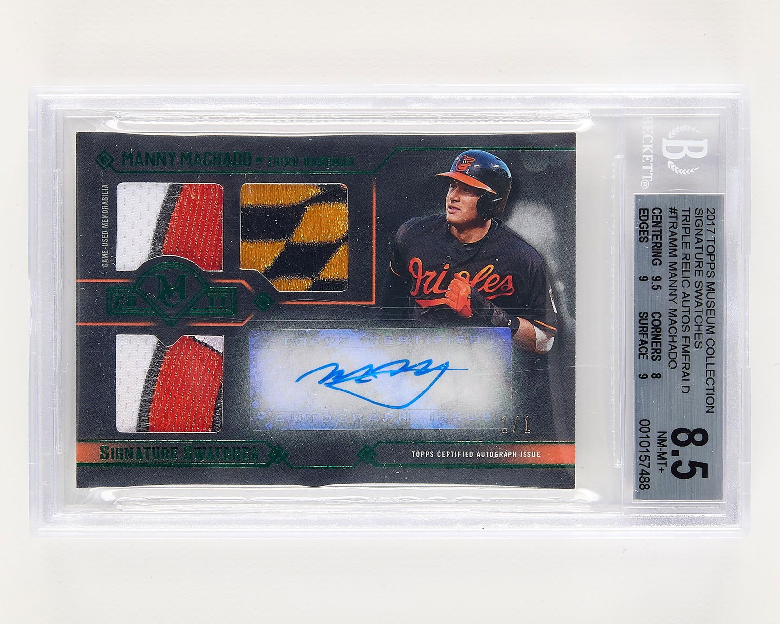 2017 Topps Mus. Col. Auto 3x Relic M. Machado BGS: 2017 Topps Museum Collection Signature Swatches Triple Relic Autographs Emerald, Manny Machado baseball card, numbered 1/1. Beckett: 0010157488.Height: 5 1/4 in x width: 3 1/4 in.