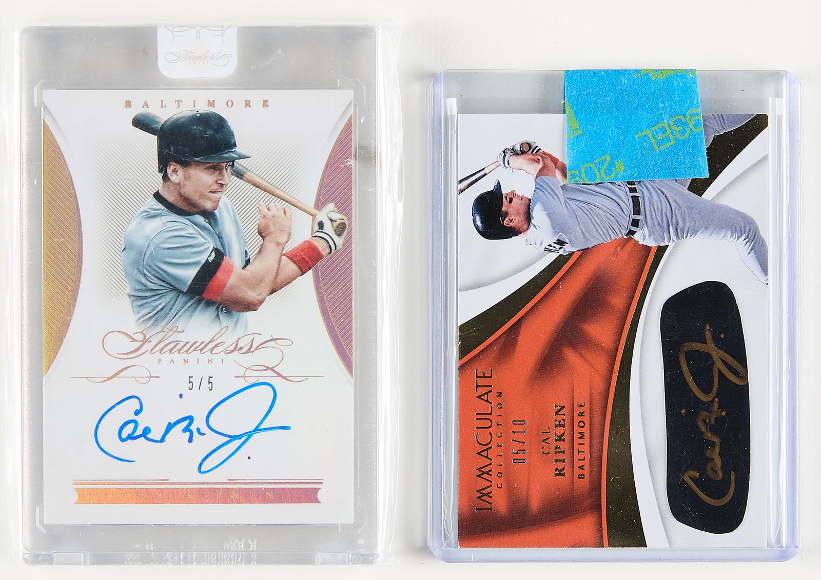 2 Panini Cal Ripken Jr Signed Cards: Group of two Panini Cal Ripken Jr. autographed baseball cards. Including:2016 Flawless Signatures, #FS-CR, 5/5.2017 Immaculate collection, #EB-CR, 5/10.(Case) height: 4 1/2 in x width: 3 in.