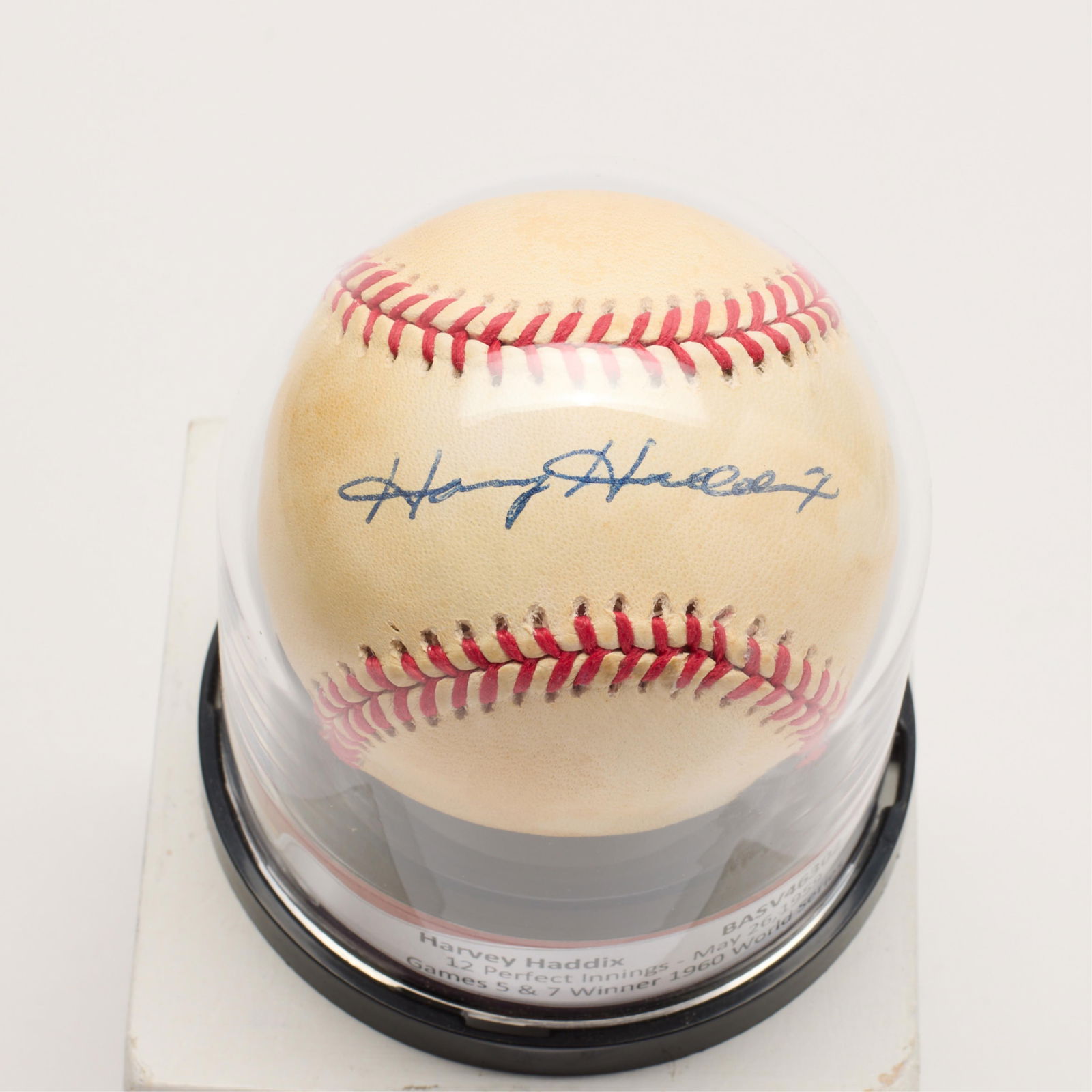 Harvey Haddix Signed Baseball BAS: Harvey Haddix autographed baseball, signed in blue ink. BAS: V46302. (Case) height: 4 in x diameter: 3 1/2 in.