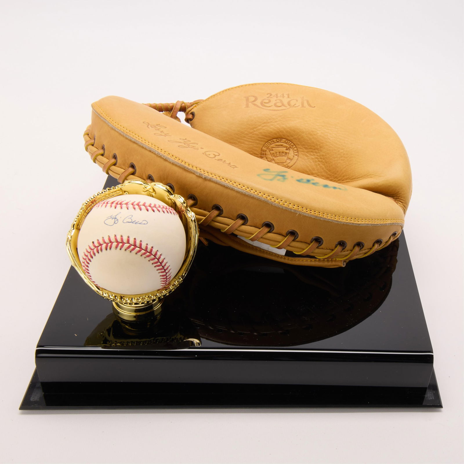 Yogi Berra Autographed Glove & Ball SGC: Yogi Berra autographed replica Reach 2441 baseball glove and baseball. Baseball, SGC: AU58938. In a Yankees branded display case. (Case) height: 10 1/2 in x width: 12 in x depth: 12 1/2 in.