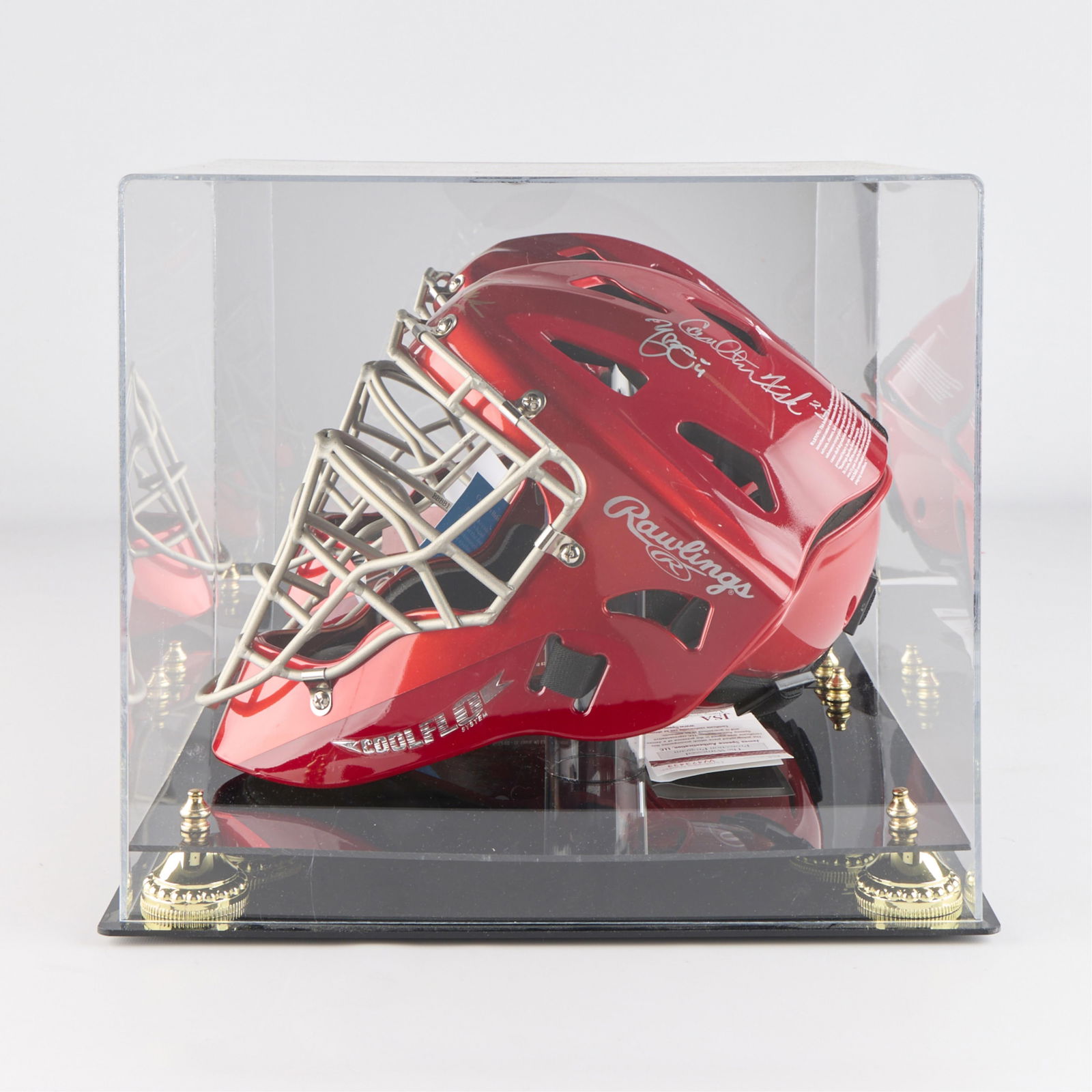 Signed Catcher's Mask - Bench, Molina, Fisk: Autographed catcher's mask with three signatures in bronze and silver sharpie. Signed by Yadier Molina (JSA: W473433), Johnny Bench (JSA: U50495), and Carlton Fisk. With the original bronze sharpie