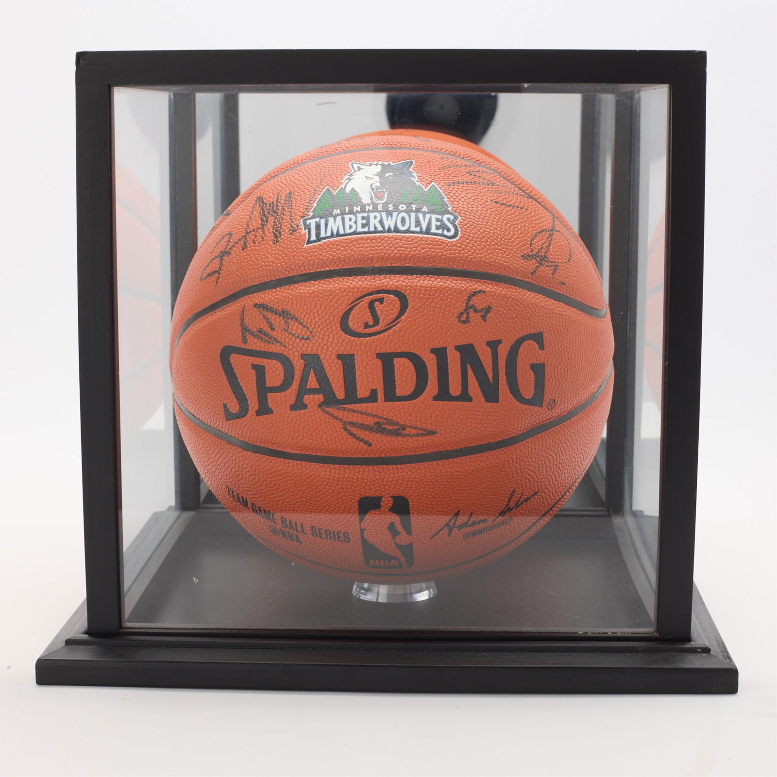 Timberwolves Team Signed Basketball: Minnesota Timberwolves team signed Spalding basketball. Signatures in black ink. With a glass/mirror case. (Case) height: 11 1/2 in x width: 12 3/4 in x depth: 12 3/4 in.