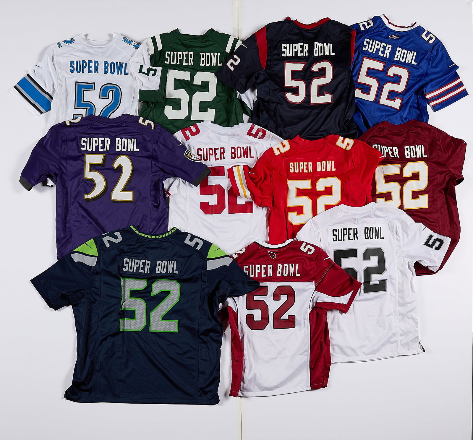 11 Superbowl 52 Football Jerseys: Group of eleven commemorative Superbowl 52 NFL jerseys. Possibly worn on-field during the Superbowl at U.S. Stadium. All with the number 52 and "Superbowl" heat-pressed onto the jersey. Including the