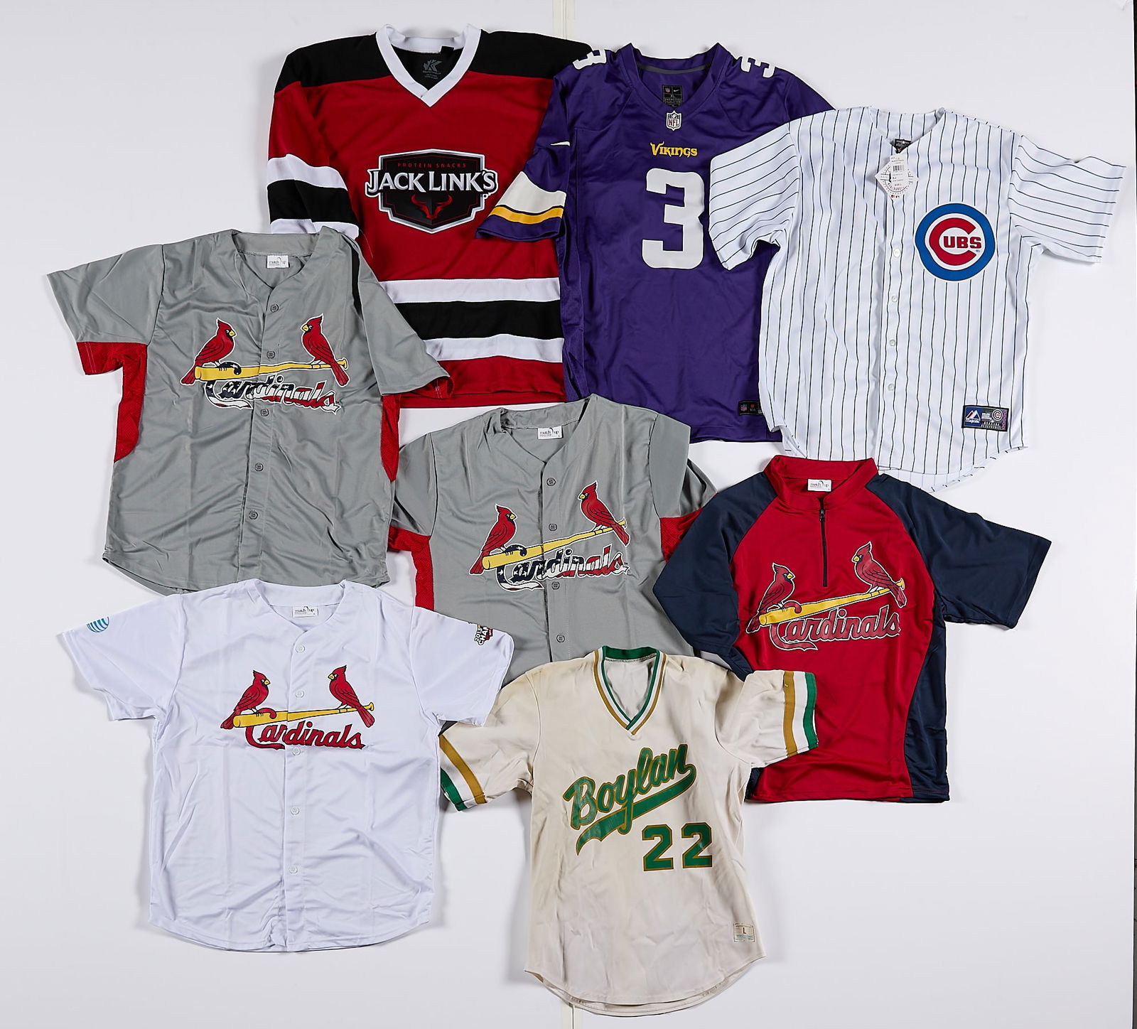 8 Jerseys - Cardinals, Cubs, Vikings: Group of eight assorted sport jerseys. Including: Chicago Cubs (L), Jack Links hockey-style jersey (M), Minnesota Vikings (XL), four St. Louis Cardinals (XL), and Boylan (L). See description for