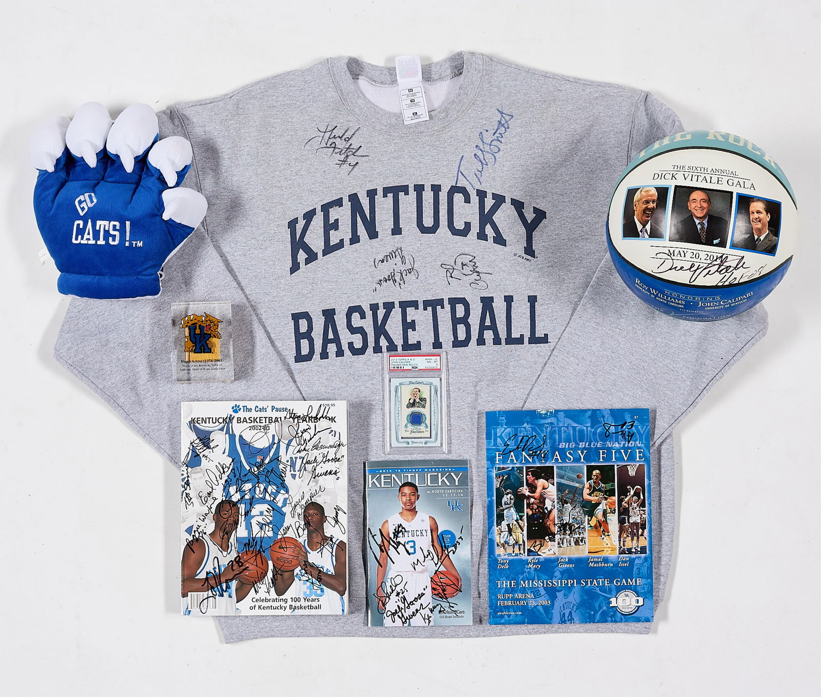 University of Kentucky Sports Ephemera: Group of sports ephemera related to the University of Kentucky and John Calipari including a sweatshirt, signed magazines, a basketball, and a plush fan hand. (Shipping) height: 14 in x width: 17 in
