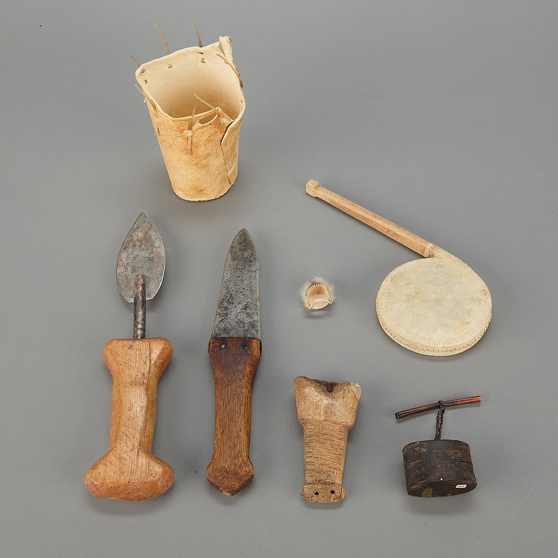 7 Pcs Assorted Inuit Tools: Group of seven Inuit tools. Including One rattle of the Northwest Territory Dog Rib People. Darlene Apangalook (Yupik/Inuit (Lingit/Inupiaq), 20th century). One hide sewing needle basket. One Inupiak
