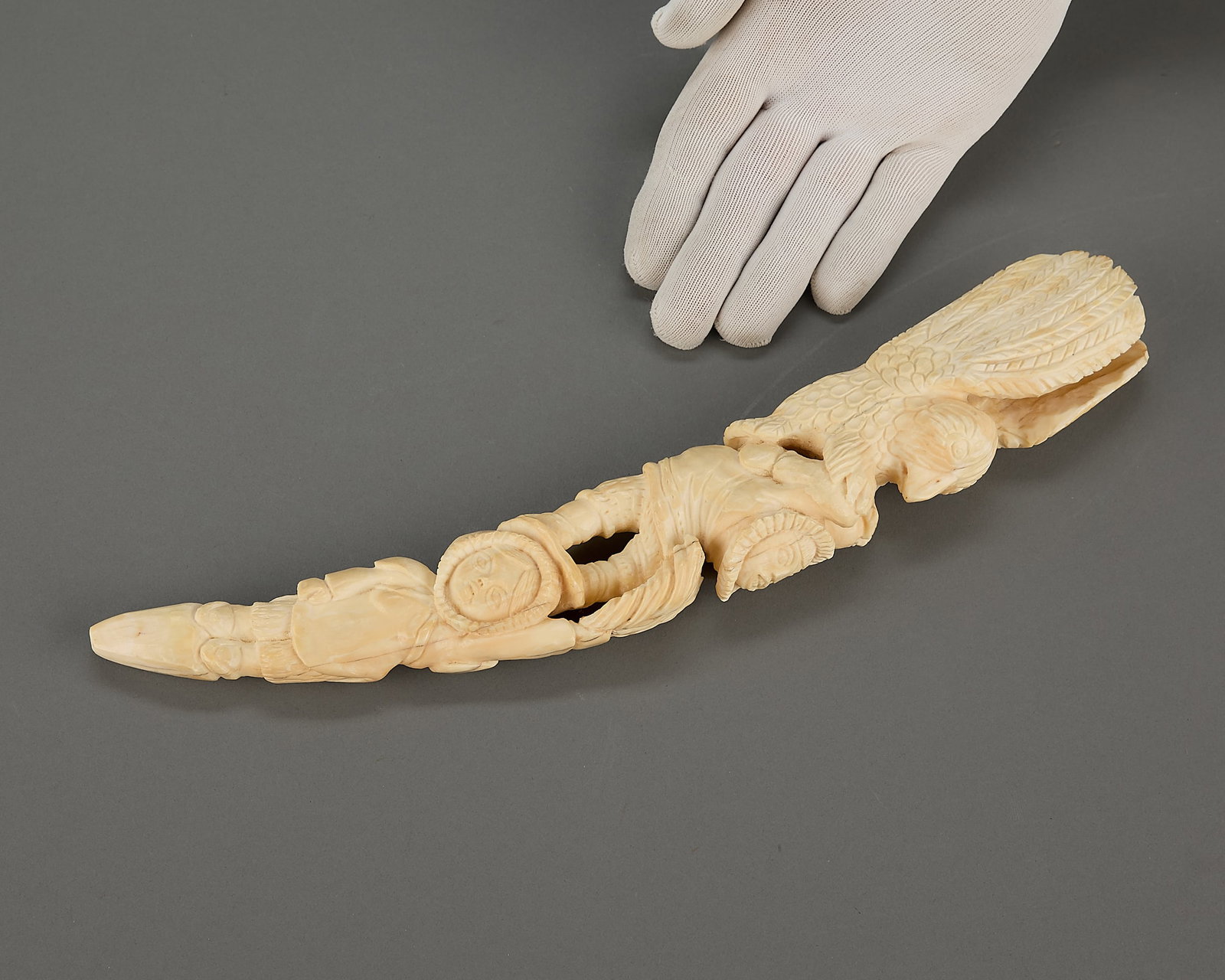 George Auksaq Totem Form Carving: George Auksaq (Inuit (Iglulik - Igloolik), b. 1963). Carved organic material in totem form featuring a bird and Inuit figures. Unsigned.Provenance: Heard Museum, Arizona; Private Collection, New York.