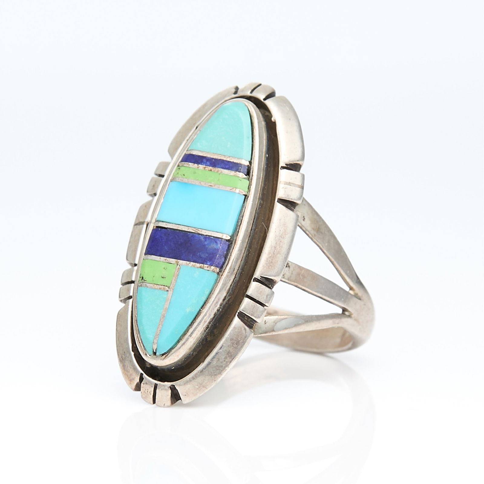 CS Encer Zuni Sterling Ring Sz 6.5: CS Encer (Zuni, b. 20th century). Sterling silver ring inlaid with turquoise, lapis and other hardstone. Marked along the the back sterling and CS Encer.Ring size: 6 1/2 US. Gross weight: 7.1 g.