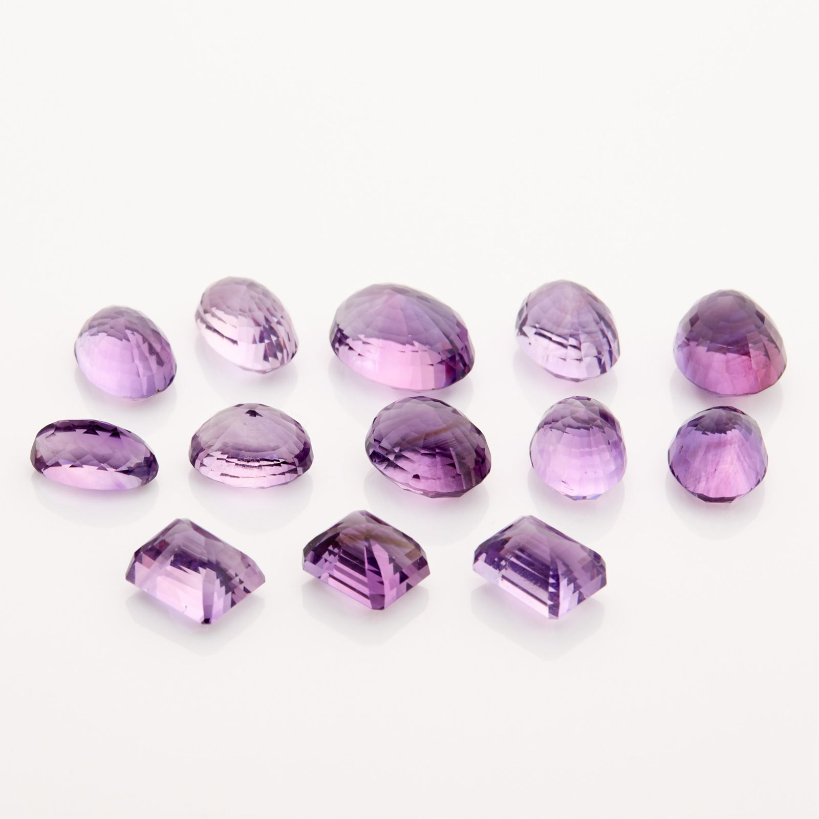 Large Group Amethysts 153.65 ctw: Group of amethysts totally 153.65 ctw in oval and step cuts. Height ranges from 12.71 mm to 19.17 mm. Width ranges from 9.44 mm to 14.32 mm. Depth ranges from 8.01 mm to 10.82 mm. Gross weight: