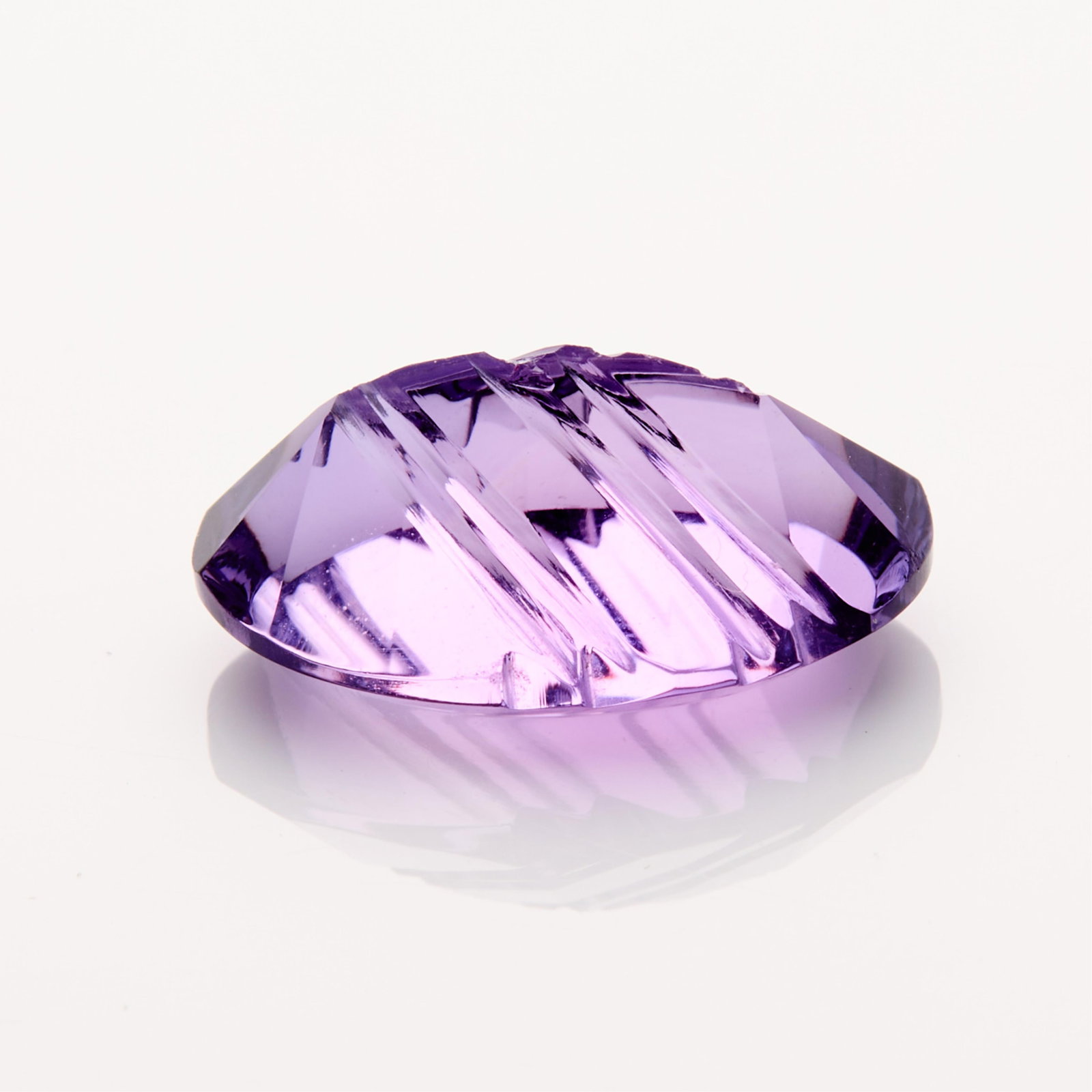 Fantasy Cut Amethyst 11 ct: One fantasy cut amethyst weighing 11 ct. Height: 18.90 mm x width: 12.41 mm x depth: 8.56 mm. Gross weight: 11.00 ctw.