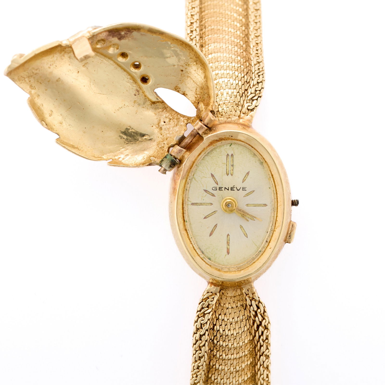 14k Gold Universal Geneve Cocktail watch: 14k yellow gold Universal Geneve cocktail watch, comprised of a textured leaf cover, set with five single cut diamonds, the cover hinges to reveal an oval watch with cream face and slash indices. On