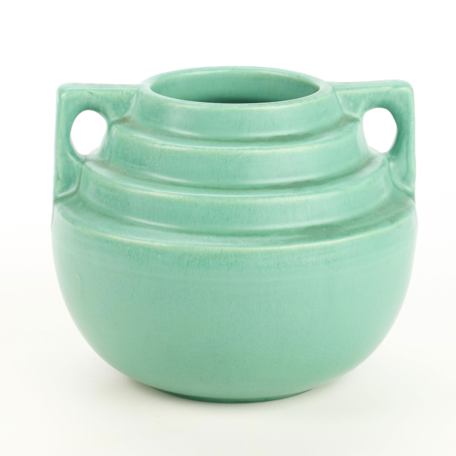 Catalina Matte Green 2-Handle Art Pottery Vase: Catalina Island Pottery (Catalina Clay Products), California. Art pottery double-handled vase with stepped shoulder, ca. 1927-1937. Marked "Catalina" along the undersideHeight: 5 1/2 in x diameter: 6